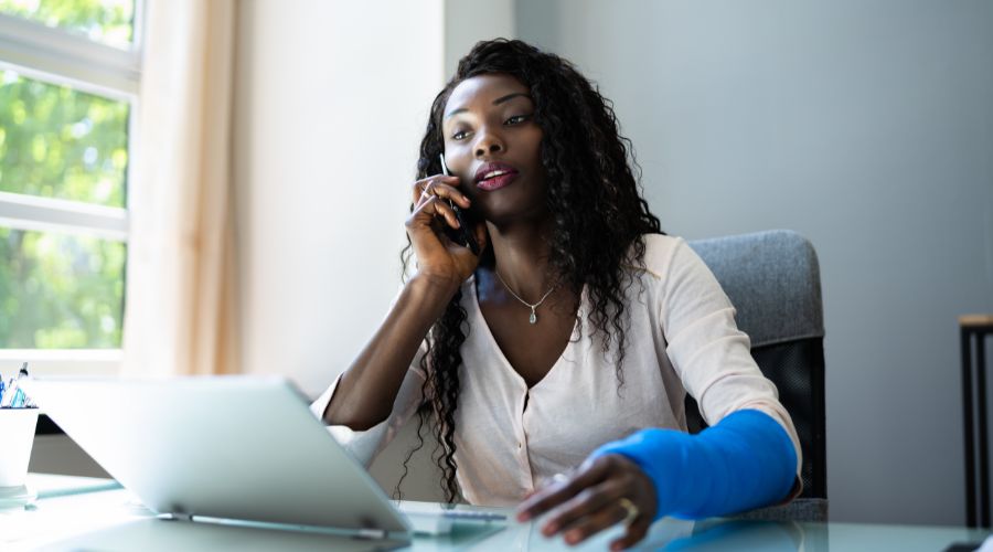 Woman wearing a cast talking on the phone